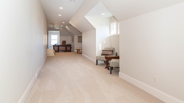 bonus room with vaulted ceiling and light carpet