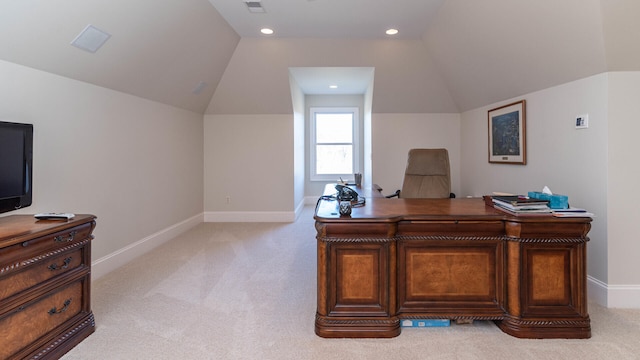 office with vaulted ceiling and light carpet