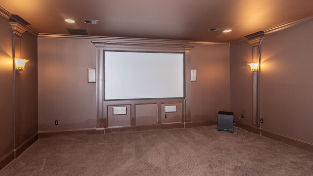 carpeted cinema room featuring ornamental molding