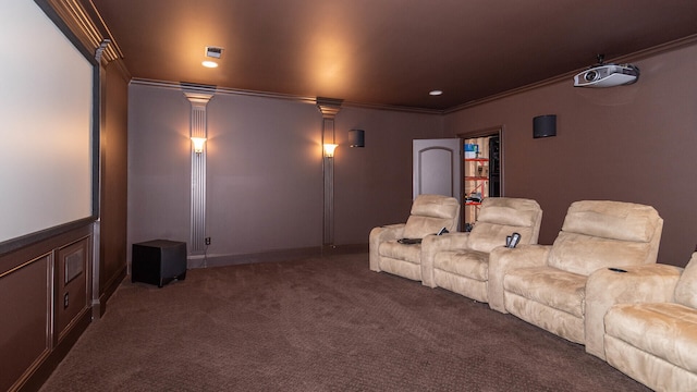 carpeted home theater featuring crown molding and decorative columns