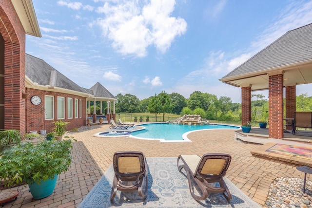 view of swimming pool with an in ground hot tub and a patio area