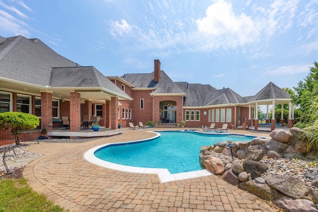 view of swimming pool with a patio