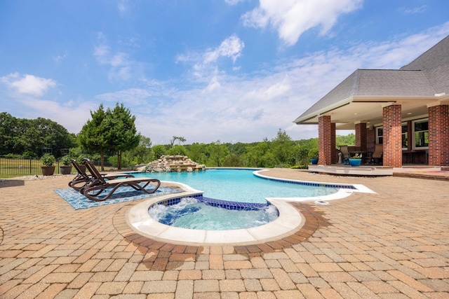 view of pool featuring an in ground hot tub and a patio area