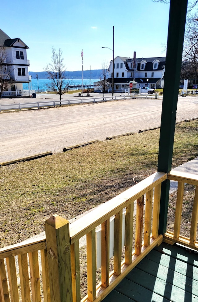 view of yard with covered porch and a water view