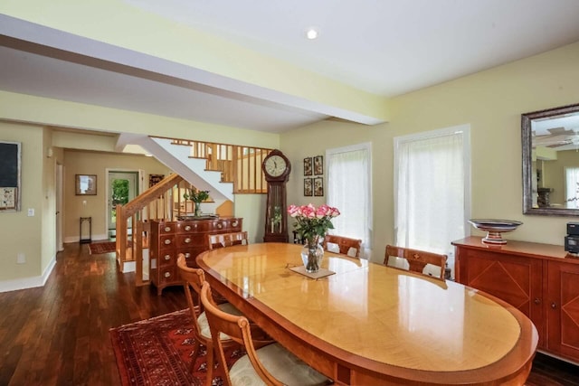 dining space featuring dark hardwood / wood-style floors and beam ceiling