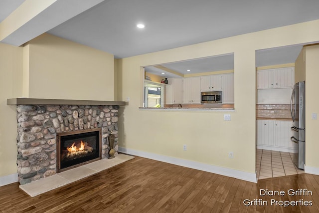 unfurnished living room featuring light hardwood / wood-style floors and a fireplace