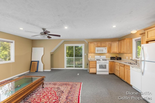 kitchen featuring light brown cabinetry, dark carpet, a textured ceiling, white appliances, and ceiling fan