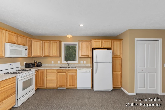 kitchen featuring light brown cabinets, sink, white appliances, and dark colored carpet