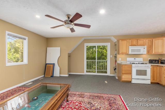 kitchen with carpet flooring, white appliances, a textured ceiling, and light brown cabinetry