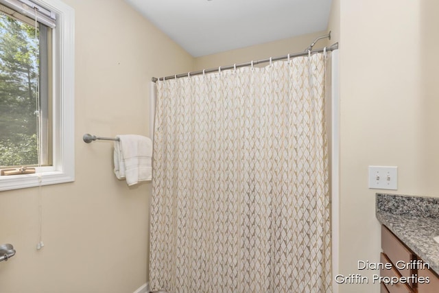 bathroom featuring plenty of natural light and vanity