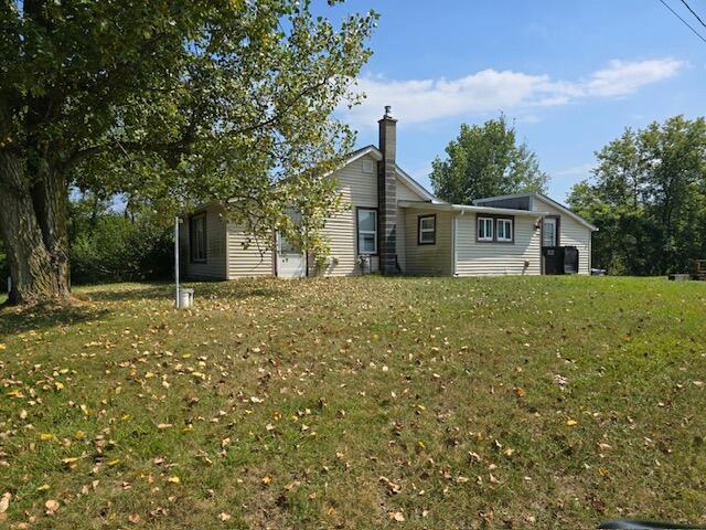 rear view of house with a yard