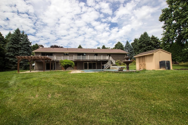 back of house with a storage shed, a yard, a deck, and a pergola