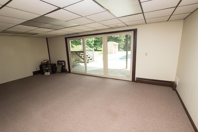 unfurnished room featuring a baseboard radiator, carpet flooring, and a paneled ceiling