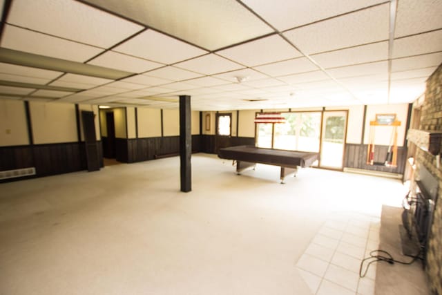 basement with a paneled ceiling, a fireplace, and billiards