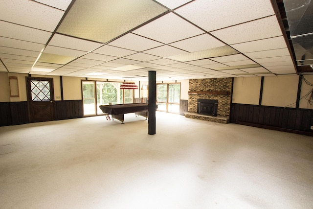 recreation room featuring pool table, a paneled ceiling, and a wood stove