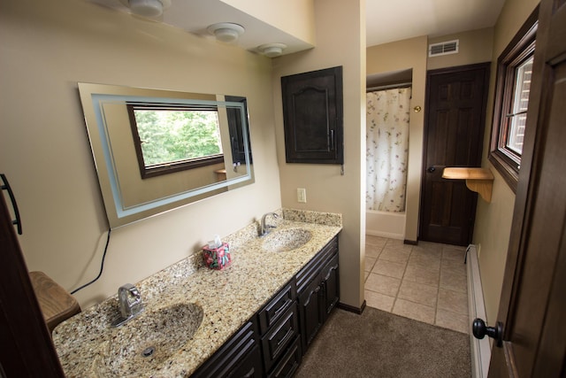 bathroom featuring vanity, tile patterned floors, and shower / bath combo with shower curtain