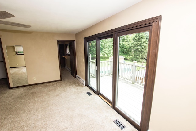 doorway to outside featuring a baseboard radiator and light carpet