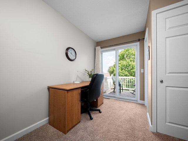 office with light colored carpet, baseboards, and vaulted ceiling