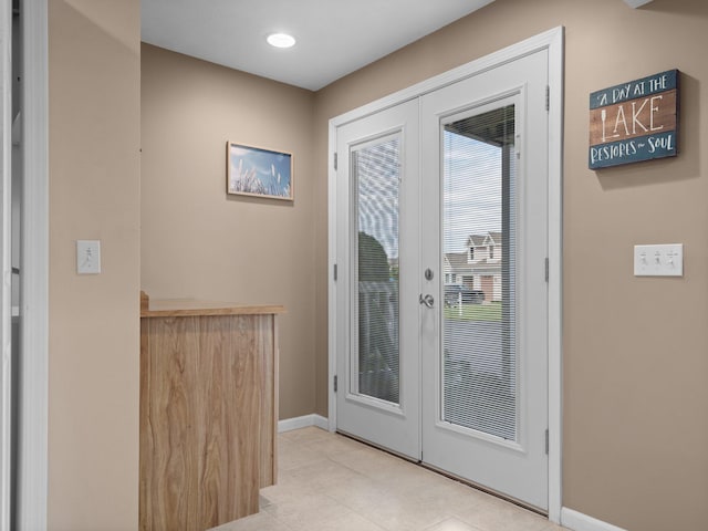 entryway with tile patterned flooring, recessed lighting, french doors, and baseboards