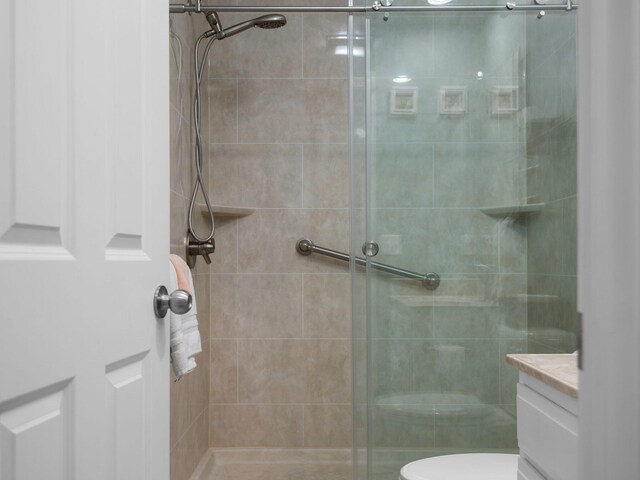 bathroom with vanity, toilet, and an enclosed shower