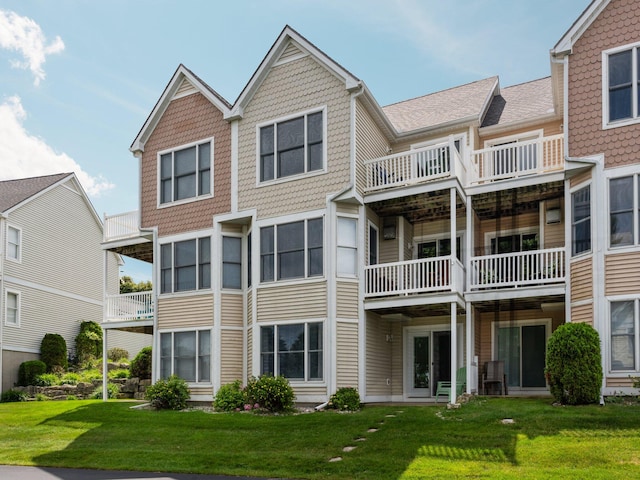 view of front of property with a balcony and a front yard