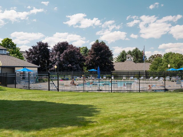 view of pool featuring a yard