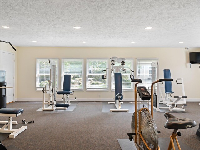 exercise room featuring a textured ceiling