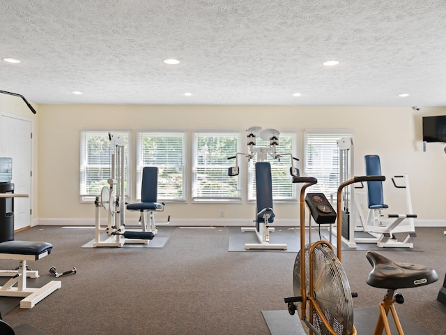 gym with recessed lighting, baseboards, and a textured ceiling