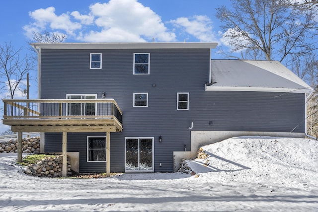 snow covered property with a wooden deck