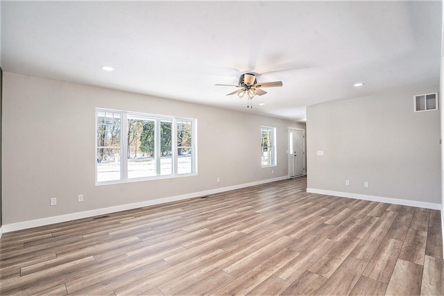 empty room with light wood-type flooring and ceiling fan