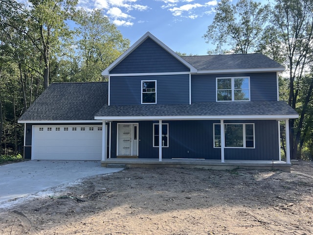 front of property featuring a porch and a garage