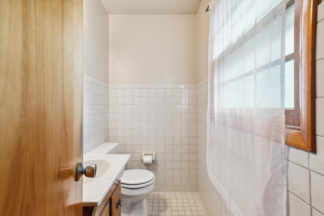 bathroom featuring tile walls, tile patterned flooring, vanity, and toilet