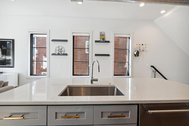 kitchen with gray cabinetry, a wealth of natural light, sink, and stainless steel dishwasher