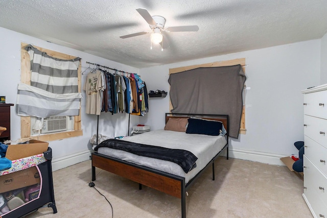 carpeted bedroom with baseboard heating, ceiling fan, a textured ceiling, cooling unit, and baseboards