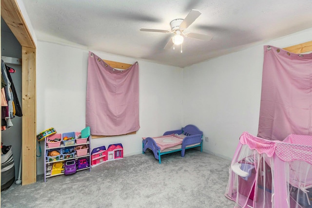 game room featuring ceiling fan, a textured ceiling, and carpet flooring