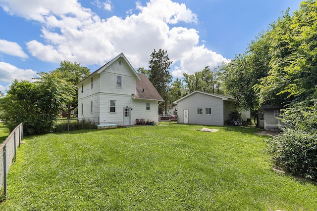 back of property with a lawn and a fenced backyard