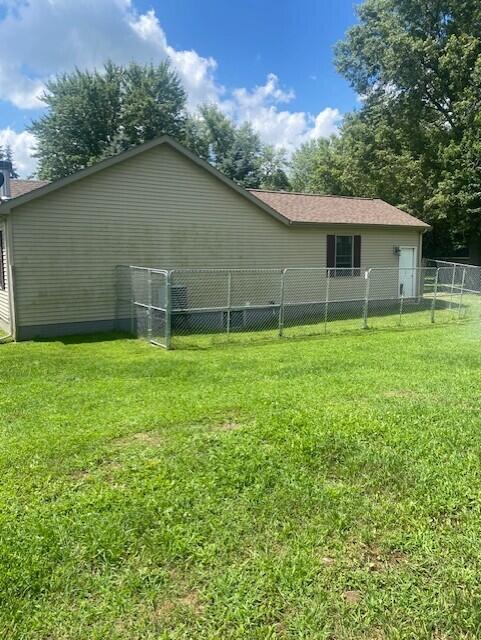 view of side of property with a yard