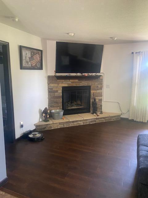 unfurnished living room featuring wood-type flooring and a fireplace