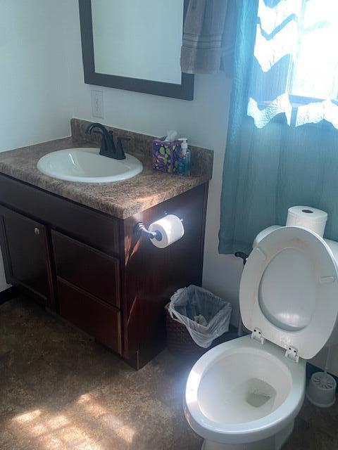 bathroom featuring vanity and toilet