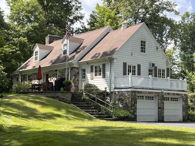 view of front of property with a garage and a front lawn