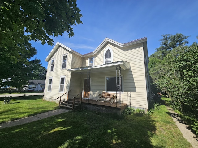 view of front of home with a front yard and covered porch