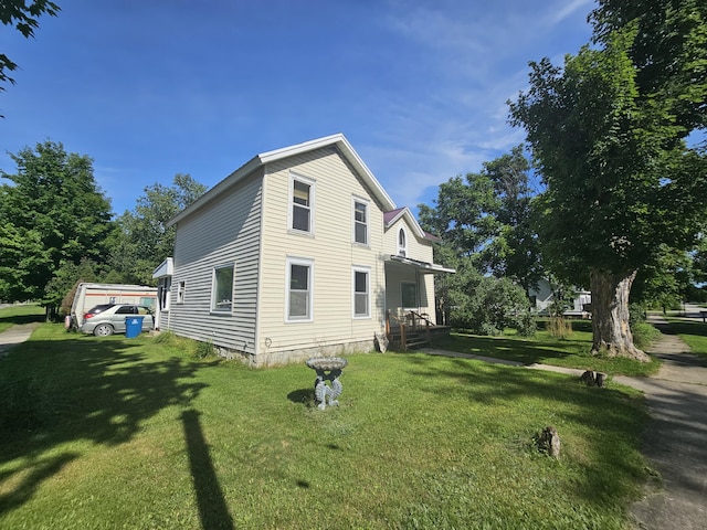 view of side of home with a lawn