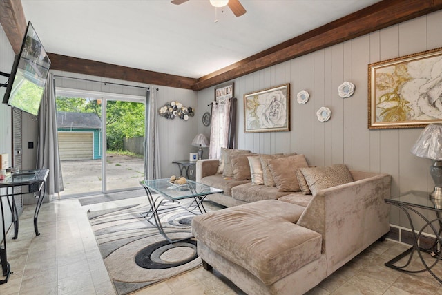 living room featuring ceiling fan and wood walls