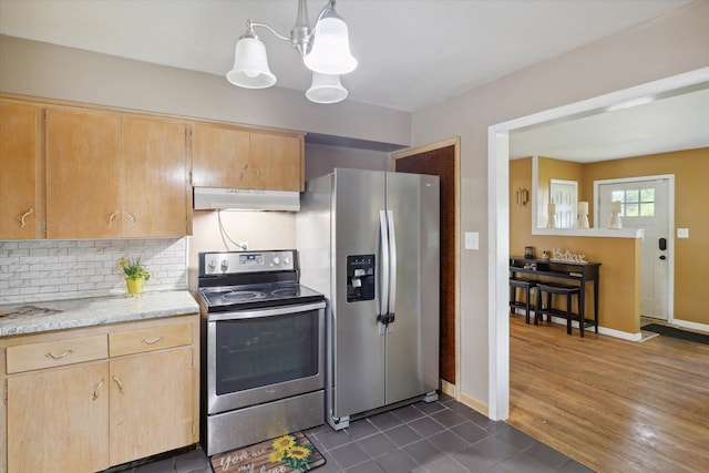 kitchen with appliances with stainless steel finishes, pendant lighting, light brown cabinets, and decorative backsplash