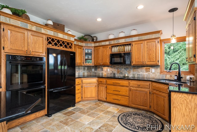 kitchen with decorative light fixtures, sink, decorative backsplash, and black appliances