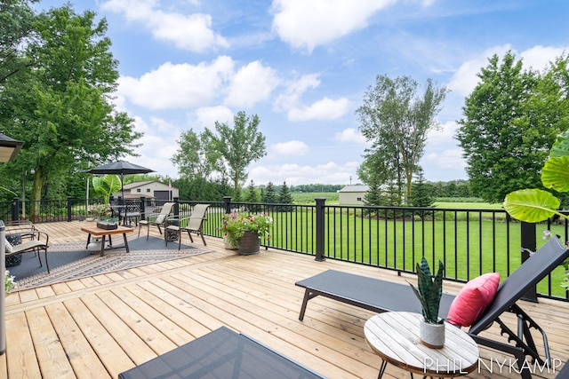 wooden terrace featuring a lawn