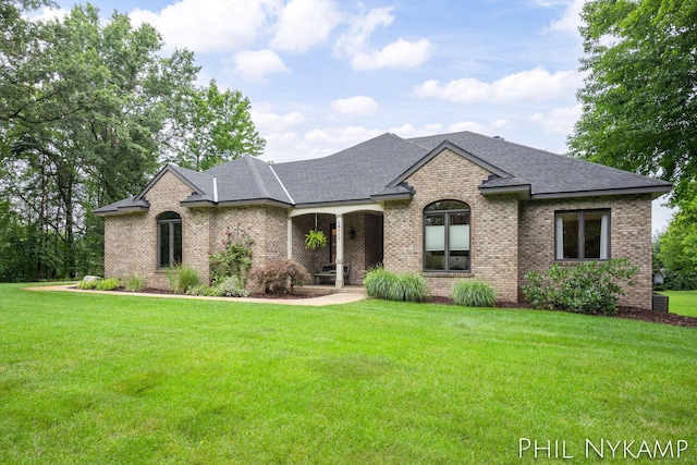 french country style house featuring a front yard