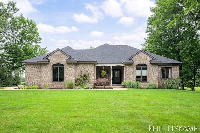 french country inspired facade featuring a front yard