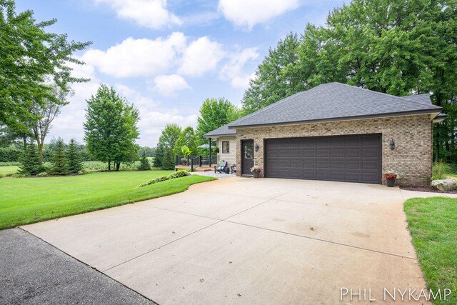 view of front of property with a garage and a front yard