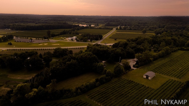 aerial view at dusk featuring a rural view